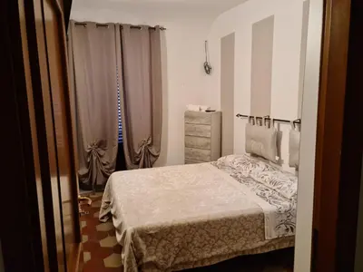 a bedroom with a bed and curtains in it at Agorà Sant’anna Apartment in Palermo