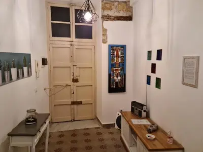 a room with a door and a table and a desk at Agorà Sant’anna Apartment in Palermo