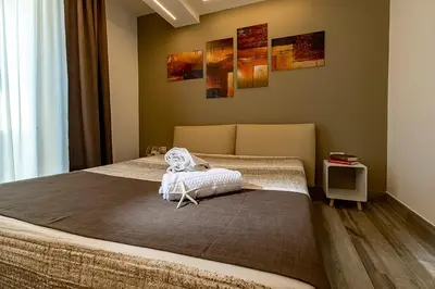 a bedroom with a large bed in a room at Sundeck Hotel in San Vito lo Capo