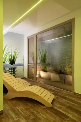 a room with a large window with a view of a garden at Sundeck Hotel in San Vito lo Capo