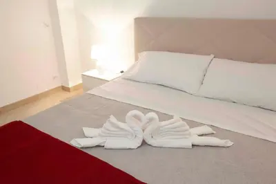 two white towels are laying on a bed at Casa vacanza da Marisa in Partinico