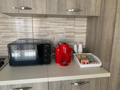 a microwave sitting on top of a kitchen counter at Casa vacanza da Marisa in Partinico
