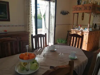 a dining room table with a bowl of fruit on it at Dimora Di Campagna in Portella di Mare