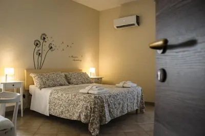 a bedroom with a bed with towels on it at Dimora Di Campagna in Portella di Mare