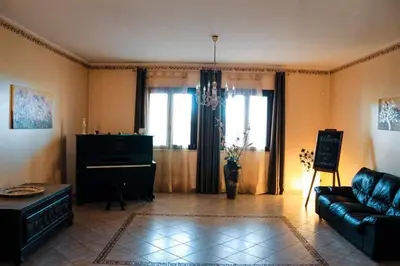 a living room with a couch and a piano at Dimora Di Campagna in Portella di Mare