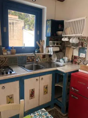 a kitchen with a sink and a window at Casa Colore Attic in Castellammare del Golfo