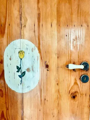 a wooden table with a drawing of a flower on it at Casa Colore Attic in Castellammare del Golfo