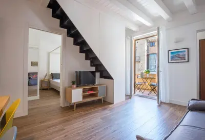 a living room with a couch and a staircase at Le Niche Holiday Homes by Wonderful Italy in Palermo