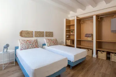 a bedroom with two beds and shelves in it at Le Niche Holiday Homes by Wonderful Italy in Palermo