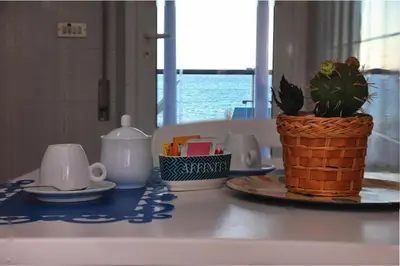 a table with a plant in a basket on a table at Terrazza sul Golfo in Alcamo