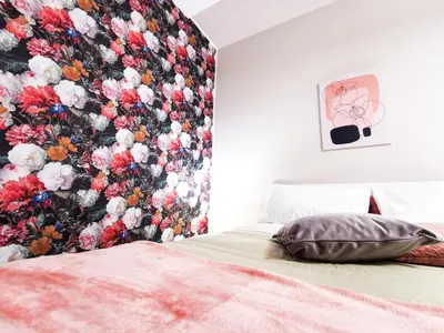 a bedroom with a floral wallpaper on the wall at Casa Ciuri in Palermo
