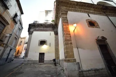 a building with a light on the side of a street at Casa Ciuri in Palermo