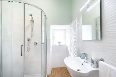 a white bathroom with a shower and a sink at GUEST HOUSE PIANA DEGLI ALBANESI in Piana degli Albanesi