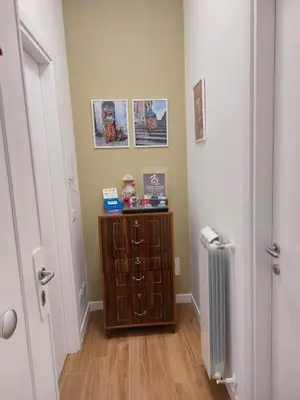 a hallway with a wooden cabinet and a radiator at GUEST HOUSE PIANA DEGLI ALBANESI in Piana degli Albanesi