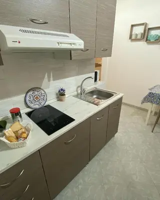 a kitchen with a sink and a counter top at Tanto di Cappello Home in Palermo
