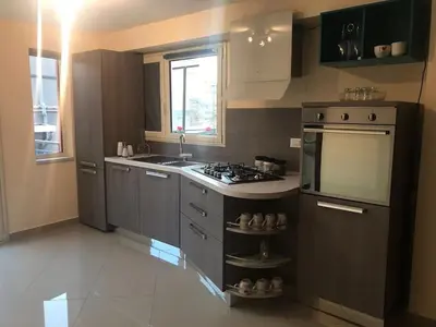 a kitchen with a stove top oven next to a sink at Casa Casteldaccia 3 in Casteldaccia