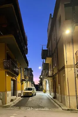 a car parked on a street between two buildings at Casa Casteldaccia 3 in Casteldaccia