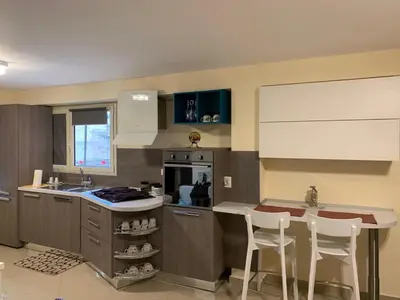 a kitchen with a counter and some chairs in it at Casa Casteldaccia 3 in Casteldaccia
