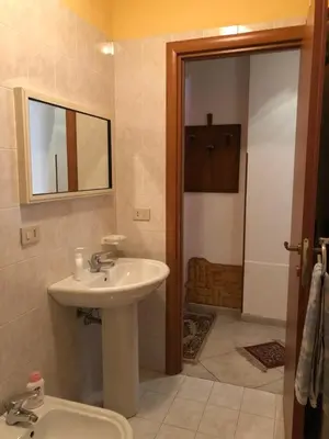 a bathroom with a sink and a mirror at Un Nido Tra Mare e Monti in Partinico