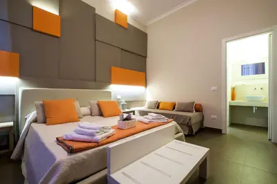 a room with a bed and a couch in it at Gran Cancelliere Apartment Parking in Palermo