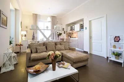 a living room with a couch and a table at Gran Cancelliere Apartment Parking in Palermo