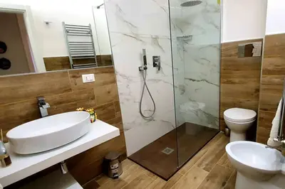 a bathroom with a sink and a shower and a toilet at LIBERTYHOUSE in Palermo