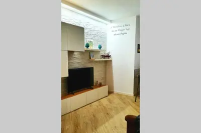 a living room with a flat screen tv on a wall at LIBERTYHOUSE in Palermo