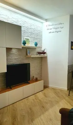 a living room with a flat screen tv on a wall at LIBERTYHOUSE in Palermo