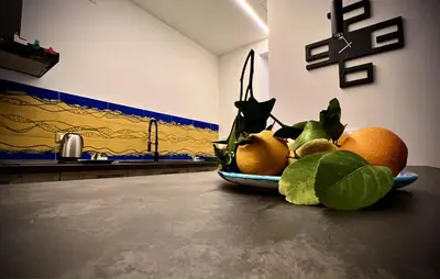 a plate of oranges and leaves on a counter at casa vacanze Sleep Art in Palermo