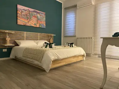 a bedroom with a large bed with a wooden headboard at casa vacanze Sleep Art in Palermo