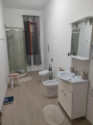 a bathroom with two toilets and a sink and a shower at Appartamento a Mondello in Mondello