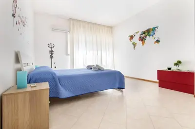 a bedroom with a blue bed in a room at La Lumia - Al Politeama in Palermo