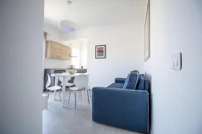 a living room with a blue couch and a table at M'Place Apartments in Palermo