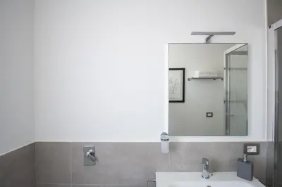 a bathroom with a sink and a mirror at M'Place Apartments in Palermo