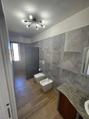 a bathroom with a toilet and a sink and a ceiling fan at Made In Sicilia -IN CENTRO, ARIA CONDIZIONATA e NO ZTL- CITY CENTRE, AIRCON and NO LTZ in Castellammare del Golfo