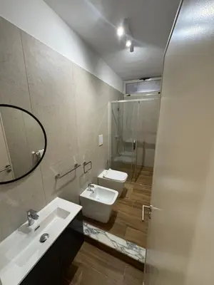 a bathroom with a sink and a toilet and a mirror at Made In Sicilia -IN CENTRO, ARIA CONDIZIONATA e NO ZTL- CITY CENTRE, AIRCON and NO LTZ in Castellammare del Golfo