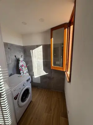 a laundry room with a washing machine and a window at Made In Sicilia -IN CENTRO, ARIA CONDIZIONATA e NO ZTL- CITY CENTRE, AIRCON and NO LTZ in Castellammare del Golfo