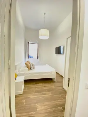a white room with a bed and a window at Medusa -IN CENTRO, ARIA CONDIZIONATA e NO ZTL -CITY CENTRE, AIRCON, NO LTZ in Castellammare del Golfo