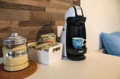 a coffee maker and a coffee mug on a counter at Casa Turà in Isola delle Femmine