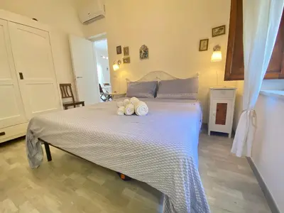 a bedroom with a bed with two candles on it at VILLA OASI a 50 mt dalla spiaggia in Alcamo Marina