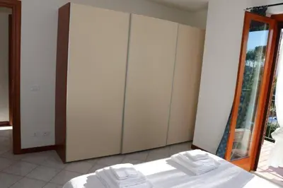 a bedroom with a bed and a large wardrobe at Villa Cavalluccio Marino con piscina idromassaggio in Carini