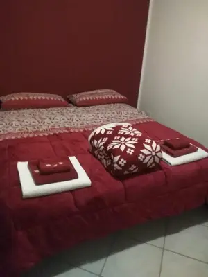 a red bed with two trays on top of it at Villa Cavalluccio Marino con piscina idromassaggio in Carini