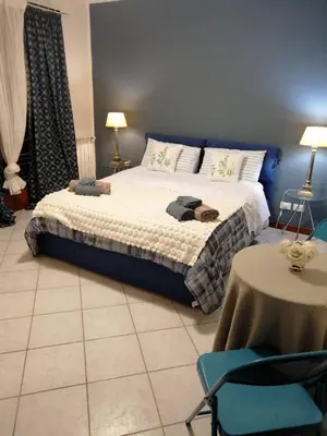 a bedroom with a bed and a table and chairs at Villa Cavalluccio Marino con piscina idromassaggio in Carini