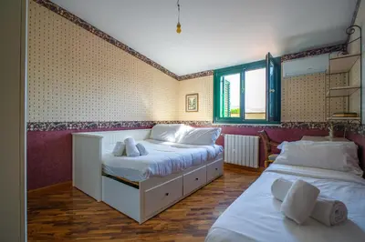 a bedroom with two beds and a window at Solemar Sicilia - Villa Anastasia in Ficarazzi