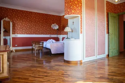 a bedroom with a bed and a table and chairs at Solemar Sicilia - Villa Anastasia in Ficarazzi
