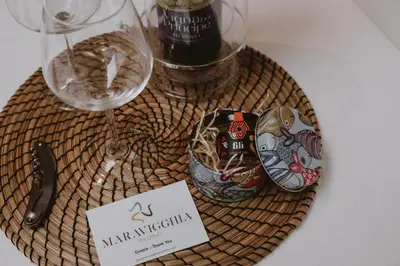 a table with two wine glasses and a sign at Paccamora by Maravigghia Palermo in Palermo