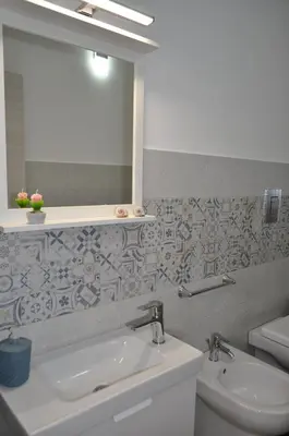a bathroom with a sink and a mirror and a toilet at Casa Vacanze Monte Cofano in Macari
