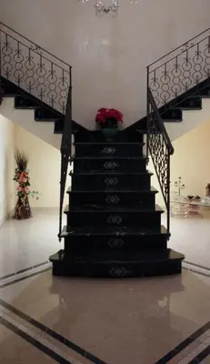 a staircase in a building with a flower in a vase at Carini Luxury Apartment vicino aereoporto e al mare in Carini