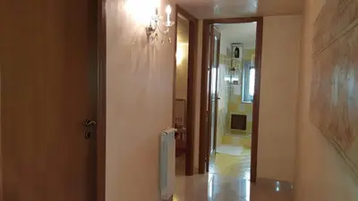 a hallway with a door to a bathroom with a toilet at Carini Luxury Apartment vicino aereoporto e al mare in Carini