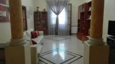 a living room with a white couch and a window at Carini Luxury Apartment vicino aereoporto e al mare in Carini